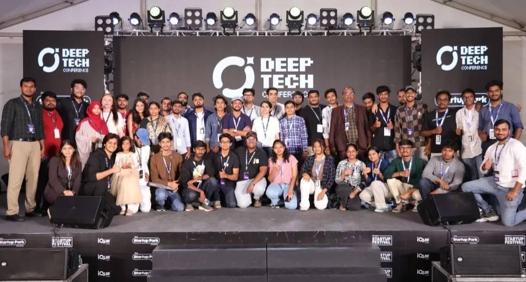 Attendees gathered on stage for a group photograph at a deep tech summit