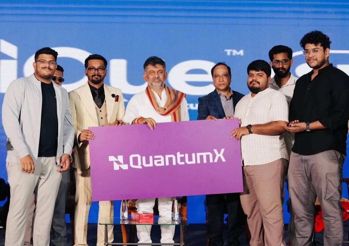 Team unveiling the QuantumX banner at a launch event