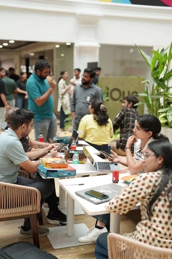 Participants working together at shared tables between sessions