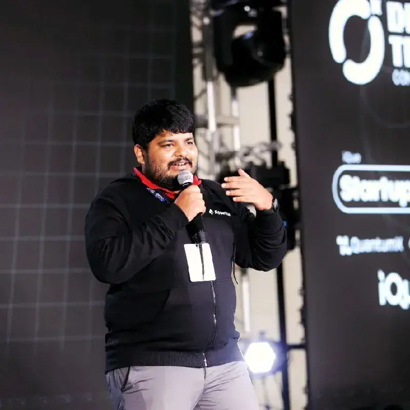 Ajmal Ibn Mohammed Althaf speaking on stage