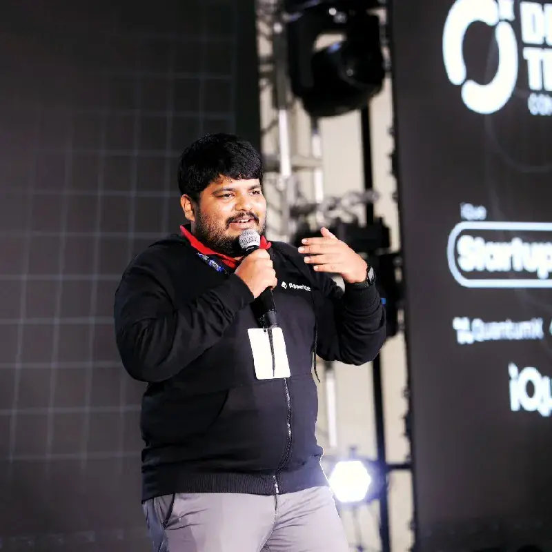 Ajmal Ibn Mohammed Althaf speaking on stage